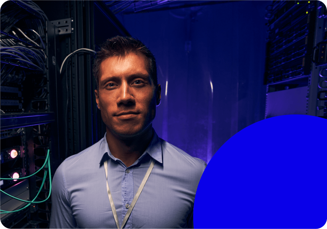 IT technician standing in a server room ensuring infrastructure maintenance